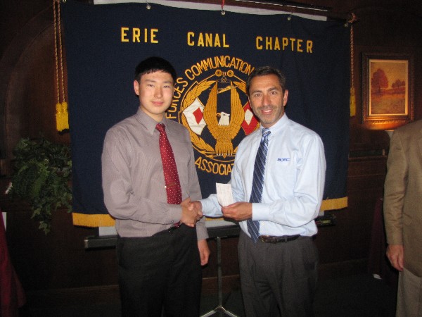 LoSecco (r) presents a $2,000 scholarship award to Jacob Hartman, a senior at Elmira Christian Academy, at the presentation in June. Hartman plans to attend State University of New York Institute of Technology in the fall.